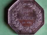 an old coin with a wreath on it on a green surface