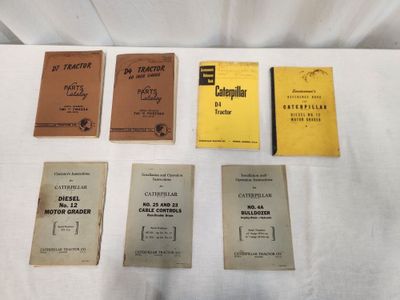 five books are lined up on a table with a white table cloth