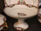 a lot of plates and bowls that are on a table