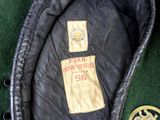 a black jacket with a badge on it next to a badge