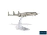 a silver model of a plane on a stand
