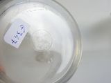 a glass jar with a sticker on it that has a sticker on it