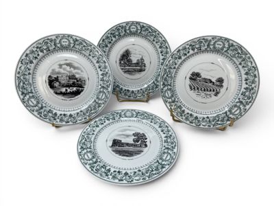 four blue and white plates with black and white images on them