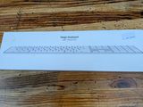 a white box with a keyboard on a wooden table