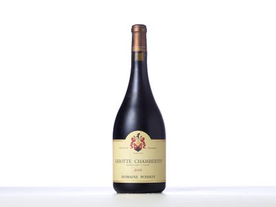 the bottle of wine is sitting on the table with a white background