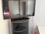 a flat screen tv sitting on a stand in a room