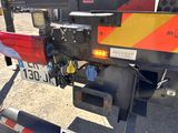 a close up of a red and yellow tow truck