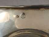 a close up of a silver plate with a number on it