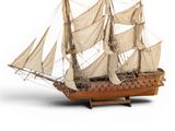 a small model of a sailboat on a white surface