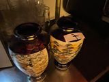 two vases sitting on a table next to each other