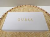 a white box sitting on top of a woven basket on top of a table