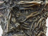 bronze sculpture of a man ' s face with hands on his face