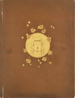 an old book with a drawing of a woman ' s face in the center