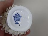 a person holding a cupcake with a blue and white design on it