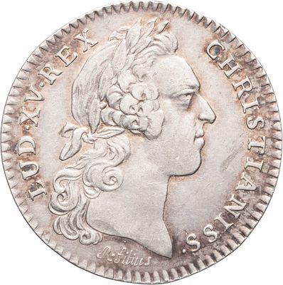 gros plan d'une pièce de monnaie sur laquelle figure une tête de femme