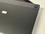 a black laptop sitting on top of a white table