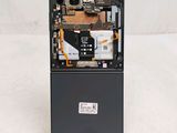 a close up of the back of a cell phone with a broken battery