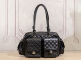a black purse sitting on a table in front of a wall