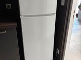 a white refrigerator and a microwave in a kitchen