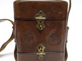 a small brown bag with a handle on a white background