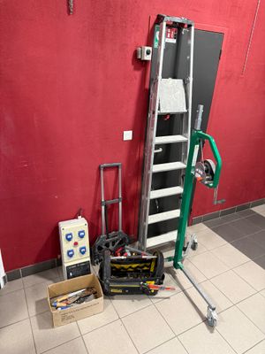 a picture of a room with a ladder and tools on the floor
