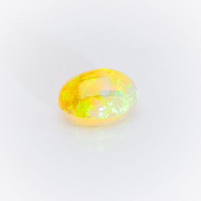 a yellow oplite gems on a white background