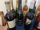 several bottles of wine are lined up on a blue table