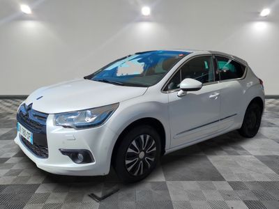 a white citrole parked on a checkered floor in a garage