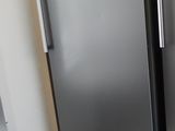 two stainless steel refrigerators side by side in a kitchen