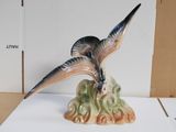 a figurine of a bird that is sitting on top of a table