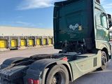 a green truck that is parked in a parking lot