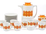 a lot of cups and a teapot on the table