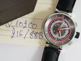 a watch sitting on top of a piece of paper next to a wallet