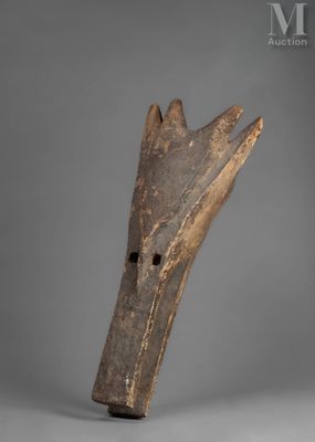 a close up of a wooden object on a gray surface