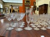many wine glasses sitting on a table in a room