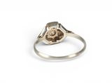 a close up of a silver ring with a diamond on it