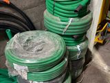 many green hoses stacked on top of each other
