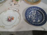 a table with plates and bowls on it and a spoon