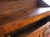 a wooden cabinet with a drawer on top of it