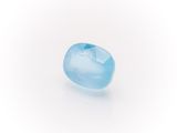 a close up of a blue topazte stone on a white surface