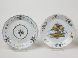 two plates with flowers and leaves on them on a white surface