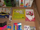 a cardboard box filled with school supplies and a calculator