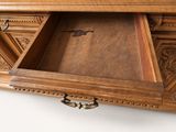 a large wooden cabinet with a drawer underneath it