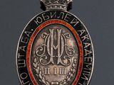 a close up of a medal with a crown on top of it