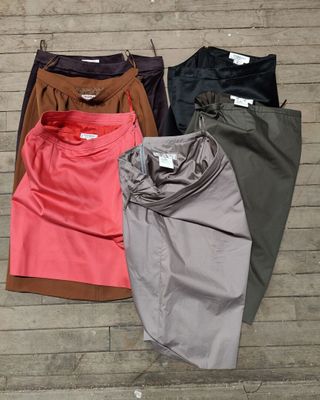 three pairs of women ' s pants are lined up on a wooden floor