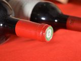 two bottles of wine sitting next to each other on a table