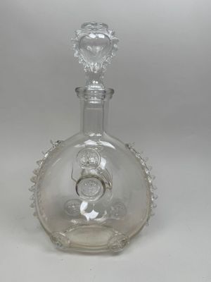 a clear glass bottle with a stopper on top of it