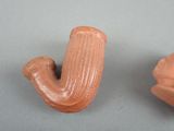 two clay objects that are sitting on a table
