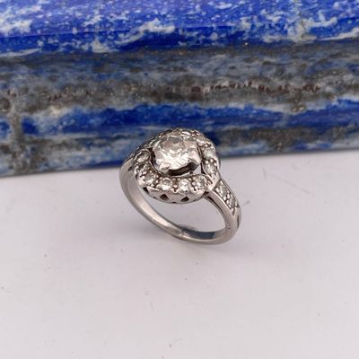 a close up of a diamond ring on a blue stone