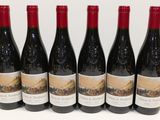 six bouteilles de vin sont alignées sur une table